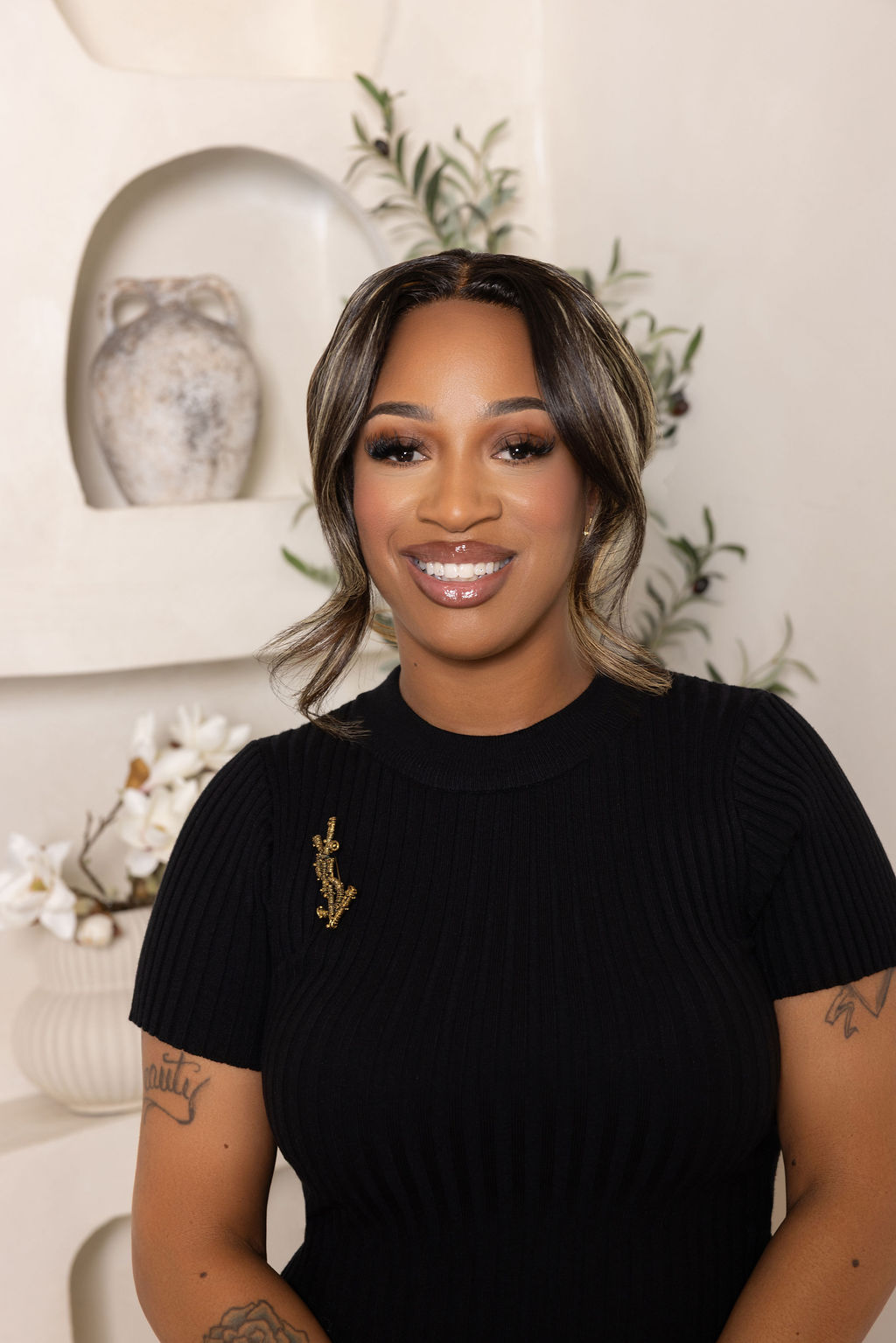 Portrait of Shae Jordan smiling, wearing a black ribbed top